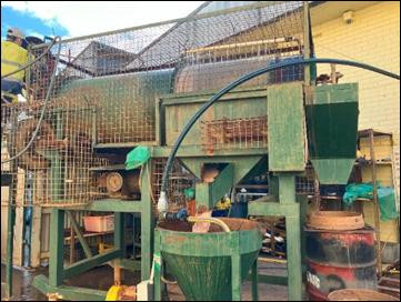 A green machine with metal bars with Mall of America in the background AI-generated content may be incorrect.