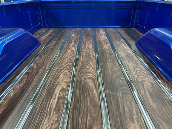 Straight-on view of the wood-grain aluminum bed floor boards